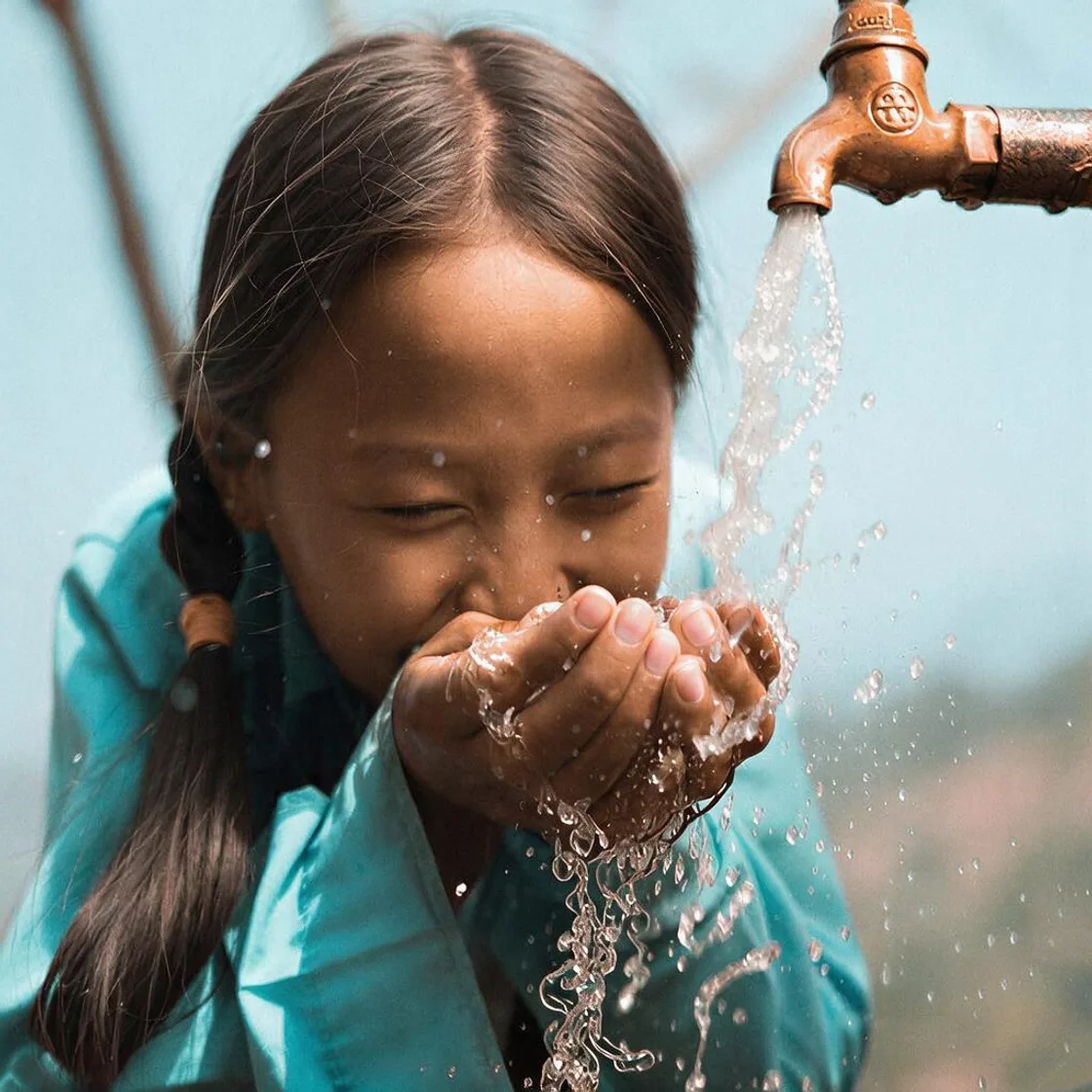 Child drinking clean water from a tap